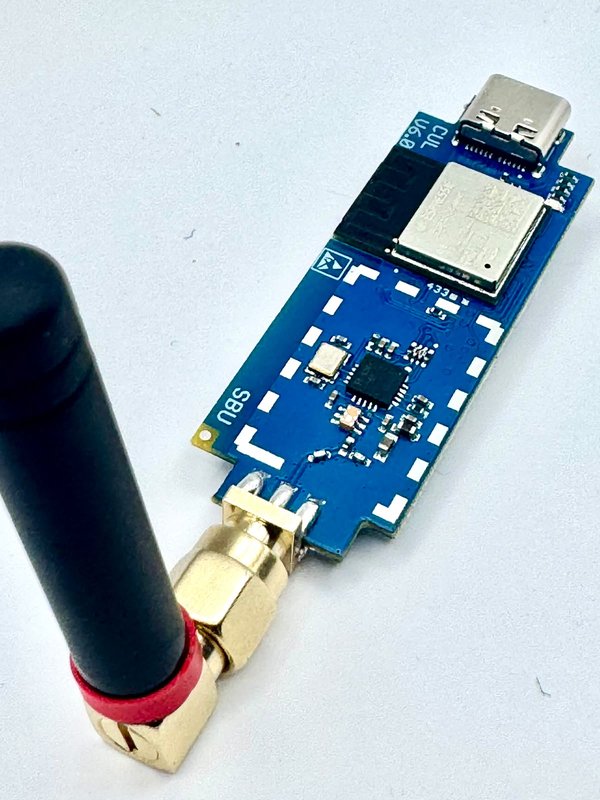 The CUL32 at an angle, with an optional stub antenna on the RP-SMA socket; the board print reads “CUL V6.0”